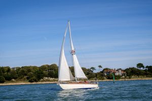 A boat navigates into the Beaulieu River