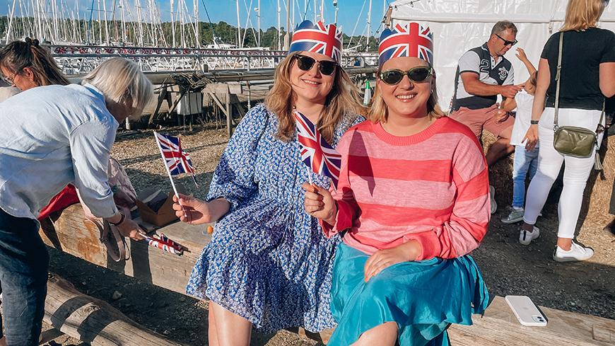 Mooring holders posing for a photography waving union jack bunting